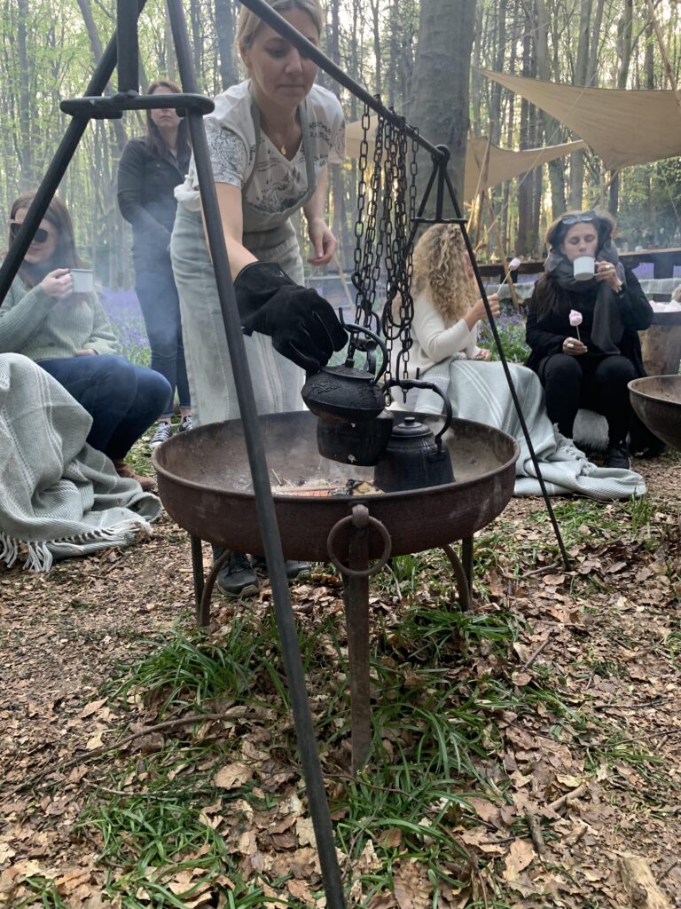 Shared experiences - tea brewing above a fire in a woodland, surrounded by bluebells