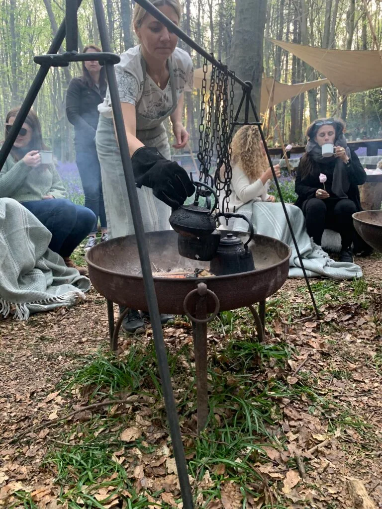 Shared experiences - tea brewing above a fire in a woodland, surrounded by bluebells