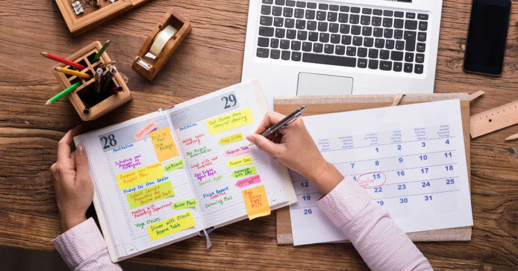 A person pours over their diary and a printed out calendar trying to work out what’s the best time of year and best day to host an event?