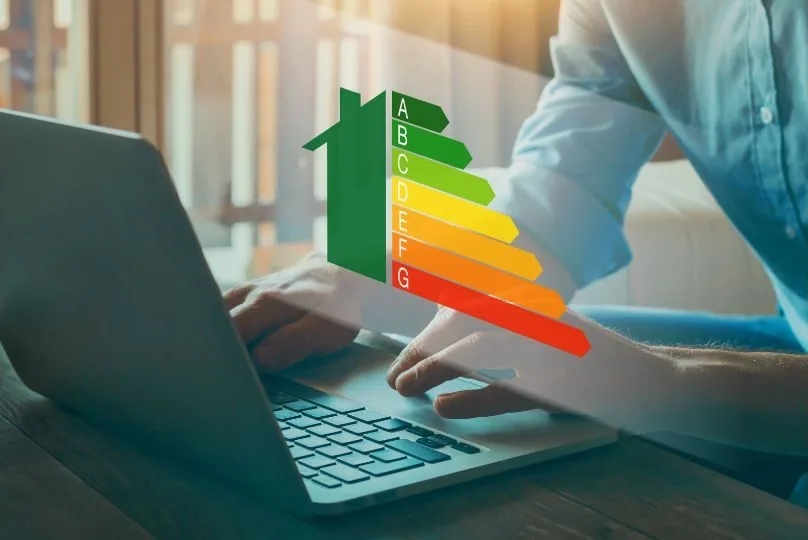 An image of a laptop, open with a man operating it, overlaid with an energy use chart