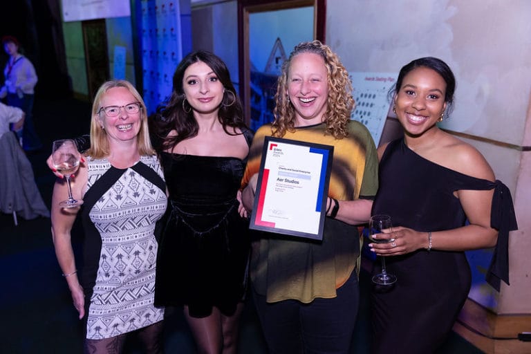 4 women holding their BIMA award and smiling