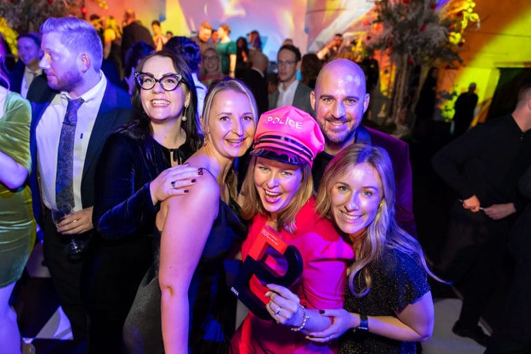 Group of people posing for photo at BIMA awards 2024 wearing some fancy dress items and smiling